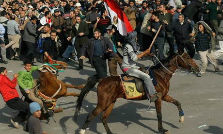  ... on horseback wield batons against protesters in Cairos Tahrir Square